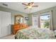 Bedroom with pond view from windows, a ceiling fan, and dresser with a TV at 380 Concordia St, Punta Gorda, FL 33983