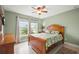 Bedroom with windows overlooking the lake, a ceiling fan, and a wooden bed frame at 380 Concordia St, Punta Gorda, FL 33983