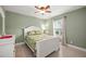 Bright bedroom with white furniture, floral bedding, and a light wall color at 380 Concordia St, Punta Gorda, FL 33983