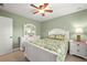 Bright bedroom featuring a ceiling fan and floral bedding on a white bed frame at 380 Concordia St, Punta Gorda, FL 33983