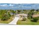 Inviting one-story home with a spacious driveway, manicured lawn and lush surroundings at 380 Concordia St, Punta Gorda, FL 33983