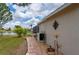 A home exterior with a brick walkway, manicured landscaping, and a view of the serene lake at 380 Concordia St, Punta Gorda, FL 33983