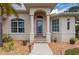Inviting front entrance with an elegant glass door, brick steps and tasteful desert landscaping at 380 Concordia St, Punta Gorda, FL 33983