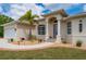 Charming home entrance with a beautiful glass door, desert landscaping, and well-lit walkway at 380 Concordia St, Punta Gorda, FL 33983