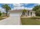 Charming single-story home with manicured lawn, lush landscaping, and a two-car garage at 380 Concordia St, Punta Gorda, FL 33983