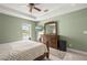 Tranquil main bedroom showcasing tray ceiling, tile floors, and outdoor access at 380 Concordia St, Punta Gorda, FL 33983