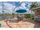 Lakeside view from a screened patio with a dining table and chairs at 380 Concordia St, Punta Gorda, FL 33983