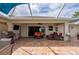 A well-equipped pool patio featuring a grill, TV, comfortable seating, and a stylish tiki bar at 380 Concordia St, Punta Gorda, FL 33983