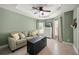 Well-lit sitting room featuring a comfortable sofa, dresser, and tile flooring at 380 Concordia St, Punta Gorda, FL 33983