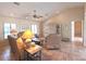 Spacious living room with a ceiling fan, comfortable seating, and decorative shelving at 4242 Rose Arbor Cir, Port Charlotte, FL 33948