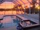 Relaxing screened-in pool with an inviting spa and sunset views at 4242 Rose Arbor Cir, Port Charlotte, FL 33948