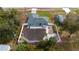 Aerial view of a home's backyard featuring a patio, landscaping, and privacy fence for outdoor enjoyment at 4373 Atwater Dr, North Port, FL 34288