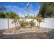 Hammock among palm trees in a gravel garden, enclosed by a white fence in the backyard at 4373 Atwater Dr, North Port, FL 34288