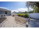 Landscaped backyard featuring rock garden, paved dining area, and tropical plants at 4373 Atwater Dr, North Port, FL 34288