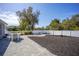 Fenced backyard with brick-paved dining area and mulched garden with palm trees at 4373 Atwater Dr, North Port, FL 34288