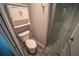 Compact bathroom featuring tiled shower, toilet, and storage at 4373 Atwater Dr, North Port, FL 34288