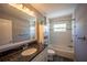 Bathroom featuring a granite countertop, gray walls, wood-look floors and white tile surround at 4373 Atwater Dr, North Port, FL 34288