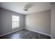 Bright bedroom featuring wood floors, neutral walls, and a large window offering natural light at 4373 Atwater Dr, North Port, FL 34288