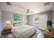 Bedroom featuring gray walls, wood-look floors, and a sliding barn door to the backyard at 4373 Atwater Dr, North Port, FL 34288