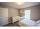 Bright bedroom featuring a dresser, grey wood flooring, and a whimsical moon decoration at 4373 Atwater Dr, North Port, FL 34288