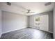 Bedroom with gray walls, wood-look floors, ceiling fan, and a sliding barn door closet at 4373 Atwater Dr, North Port, FL 34288