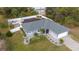 Aerial view of a gray single-story home showcasing a pristine lawn, fenced backyard, and a paved driveway at 4373 Atwater Dr, North Port, FL 34288