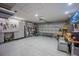 Well-organized garage with storage cabinets, work bench, speckled floors and garage door at 4373 Atwater Dr, North Port, FL 34288