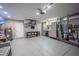 Well-equipped garage featuring speckled floor, overhead storage, tool racks and gray cabinets at 4373 Atwater Dr, North Port, FL 34288