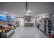 Spacious garage with speckled flooring, water heater, overhead storage, and well-organized cabinets at 4373 Atwater Dr, North Port, FL 34288