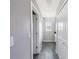 Hallway with gray walls, wood-look floors, and white trim on the doors and baseboards at 4373 Atwater Dr, North Port, FL 34288