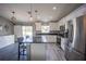 Modern kitchen featuring stainless steel appliances, granite countertops, a stylish island, and luxury vinyl plank flooring at 4373 Atwater Dr, North Port, FL 34288
