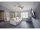 Bright living room features luxury vinyl plank flooring, a comfortable sofa, ceiling fan, and plantation shutters on the window at 4373 Atwater Dr, North Port, FL 34288