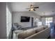 Bright living room showcasing luxury vinyl plank flooring, a comfortable sofa, ceiling fan, and plantation shutters at 4373 Atwater Dr, North Port, FL 34288