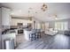 A well-lit open-concept living area showcases a modern kitchen, living room, and luxury vinyl plank flooring at 4373 Atwater Dr, North Port, FL 34288