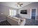 Open-concept living room featuring light gray walls, wood-look floors, and plenty of natural light at 4373 Atwater Dr, North Port, FL 34288