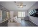 Bright living room features luxury vinyl plank flooring, a comfortable sofa, ceiling fan, and plantation shutters on the window at 4373 Atwater Dr, North Port, FL 34288