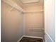 Empty walk-in closet features neutral walls, wood floors, and wire shelving for organization at 4373 Atwater Dr, North Port, FL 34288