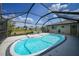 Screened-in pool with clear water, patio, and a well-maintained yard at 446 Sunnyside, Venice, FL 34293