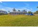 Expansive backyard with lush green lawn, above-ground pool, and partially fenced perimeter at 628 Tarpon Way, Punta Gorda, FL 33950