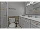Bathroom featuring marble countertop, decorative wood paneling, and glass enclosed shower at 628 Tarpon Way, Punta Gorda, FL 33950