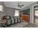 Well-lit bedroom featuring hardwood floors, dresser, and stylish ceiling fan at 628 Tarpon Way, Punta Gorda, FL 33950