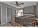 Charming bedroom with a four-poster bed, ceiling fan, and tile flooring at 628 Tarpon Way, Punta Gorda, FL 33950