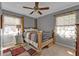 Bright bedroom features a wooden bed frame, neutral wall colors, and matching curtains at 628 Tarpon Way, Punta Gorda, FL 33950