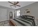 Cozy bedroom featuring a ceiling fan, wood-look flooring, and a comfortable queen-sized bed at 628 Tarpon Way, Punta Gorda, FL 33950