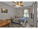Cozy bedroom with a gray color scheme, wood dresser, and window with curtains at 628 Tarpon Way, Punta Gorda, FL 33950