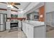 Bright kitchen features white cabinets, stainless steel appliances, and stylish marble countertops at 628 Tarpon Way, Punta Gorda, FL 33950