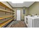 Spacious laundry room with modern washer/dryer and built-in shelving at 628 Tarpon Way, Punta Gorda, FL 33950