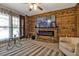 Beautiful living room featuring stylish wood accent wall with fireplace and decor at 628 Tarpon Way, Punta Gorda, FL 33950