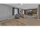 Spacious living room featuring stylish furnishings, wood accent wall, and tile flooring at 628 Tarpon Way, Punta Gorda, FL 33950