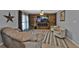 Cozy living room with a wood-paneled wall, electric fireplace, and stylish decor at 628 Tarpon Way, Punta Gorda, FL 33950